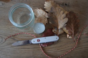 Alles was Ihr für ein Windlicht braucht: Taschenmesser (Schweizer), Teelicht, Laub, eine Schnur/Band und ein leeres Glas. Foto (c) kinderoutdoor.de