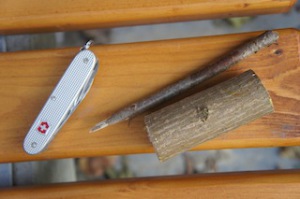 Hier ist das Material zum Schnitzen von einem Pinguin: Ein dickes Stück Holz, einen dünnen Ast und ein Taschenmesser.  foto (c) kinderoutdoor.de